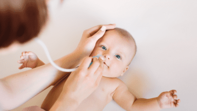 Parent Using Nasal Aspirator On Happy Baby 1.png