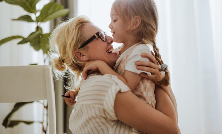 Happy Mom Embracing Her Cute Daughter At Home 1768580414 1257x838.jpeg