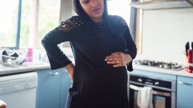 Woman Standing In Kitchen While Having Strong Back Pain. 902746596 1257x838 1.jpeg