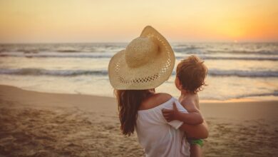 Mother With Son Enjoying Sunset On The Beach 1136033092 1258x839.jpeg