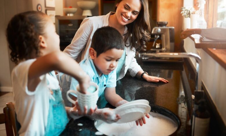 Young Happy Mixed Race Mother Washing The Dishes.jpeg